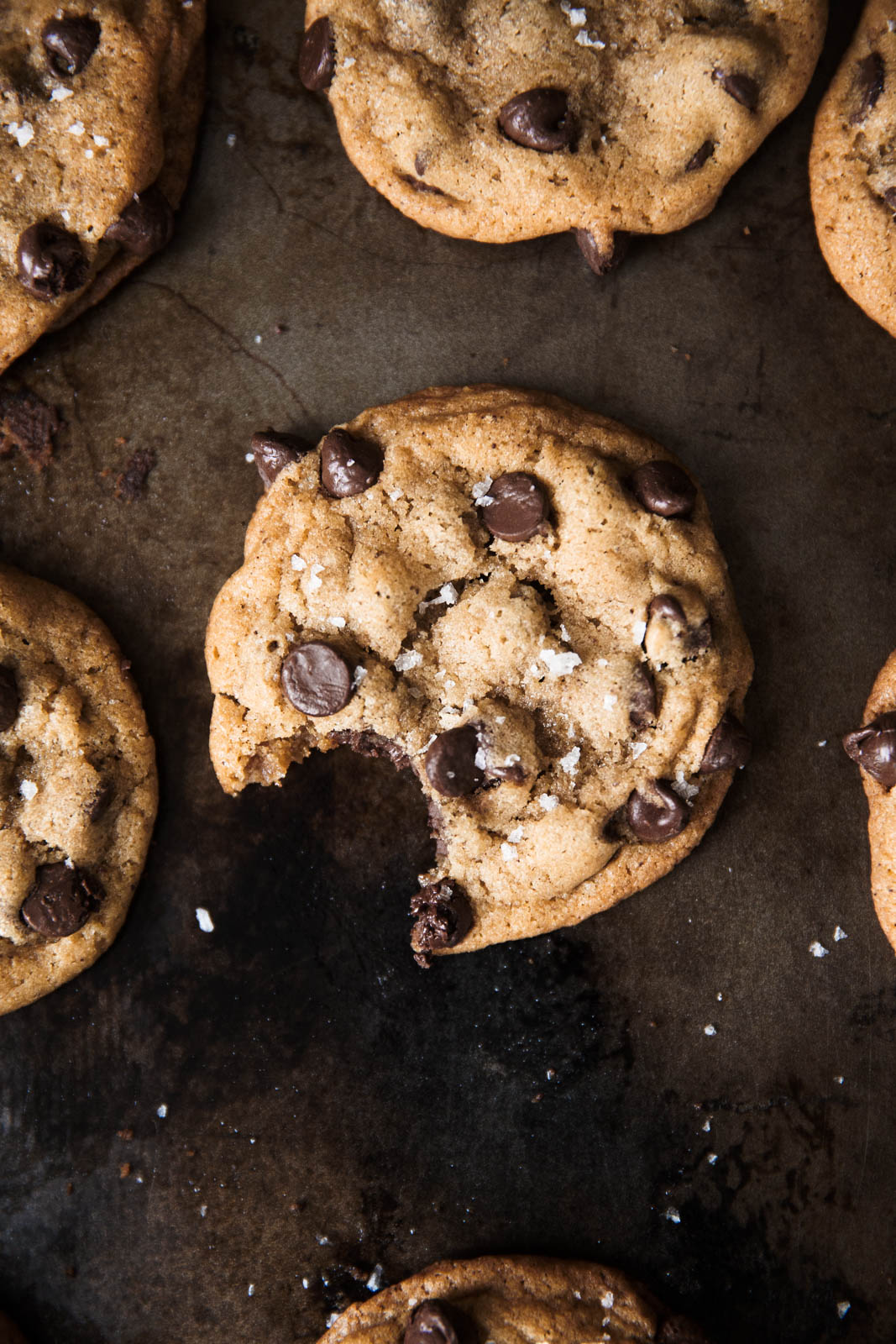 Best Brown Butter Chocolate Chip Cookies on a baking sheet with a bit taken out