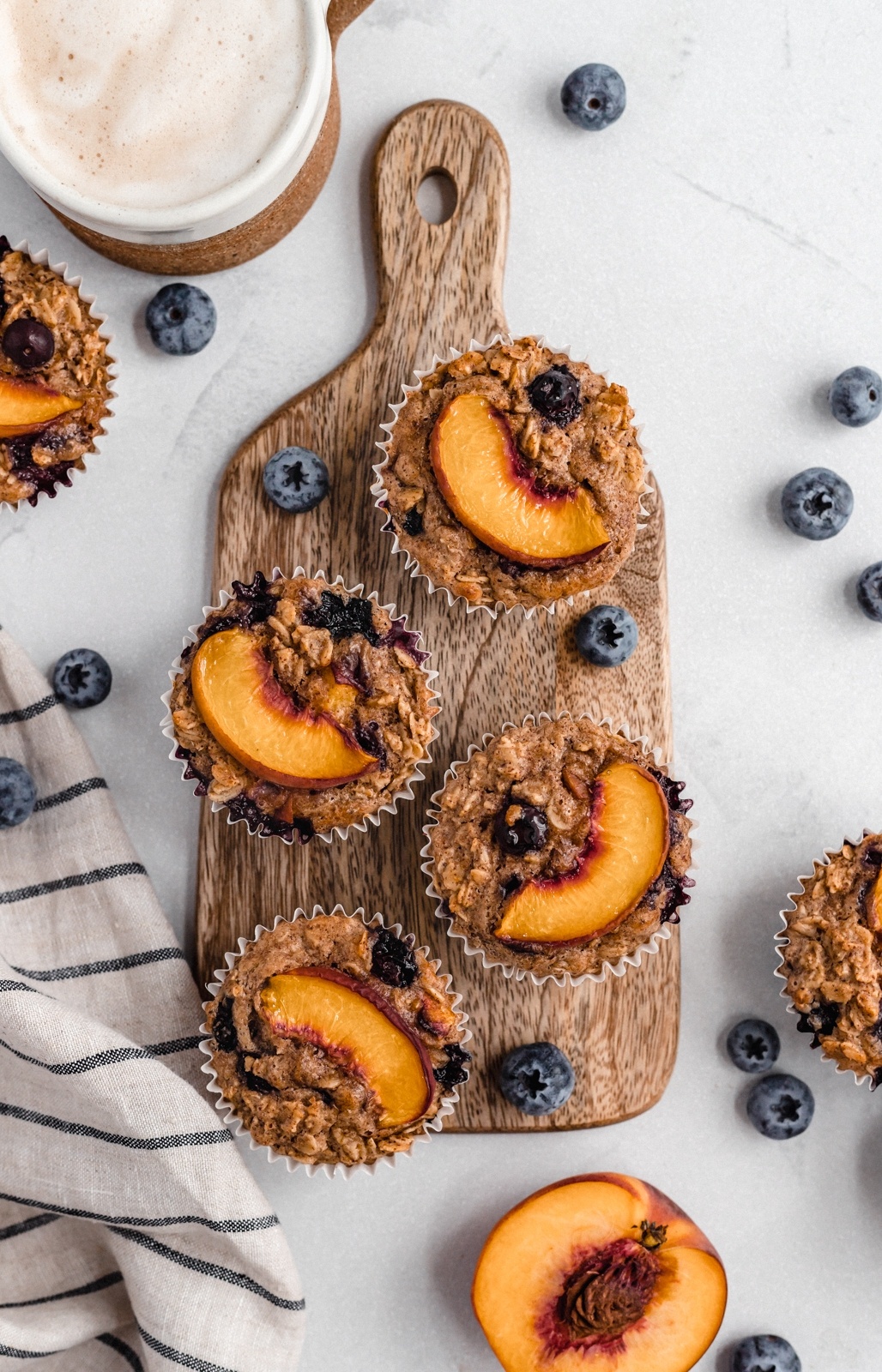 peach blueberry oatmeal cups on a wooden board