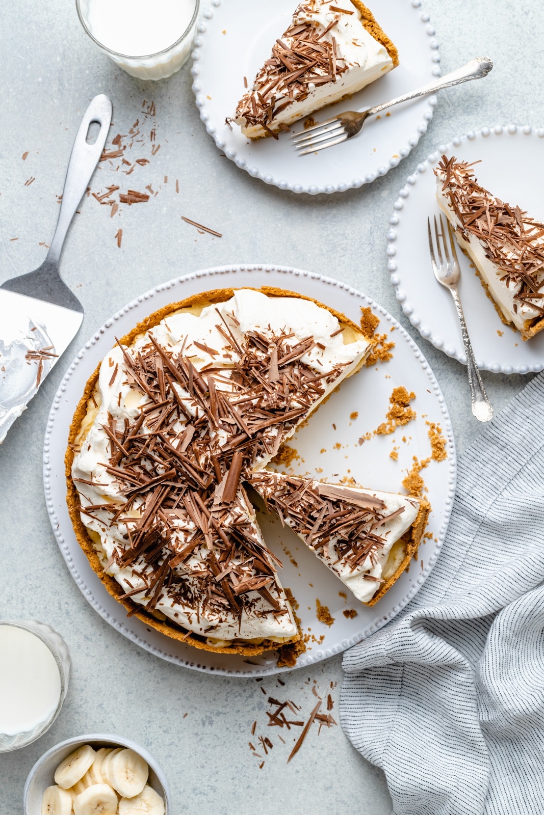 the best banana cream pie topped with chocolate shavings on a platter