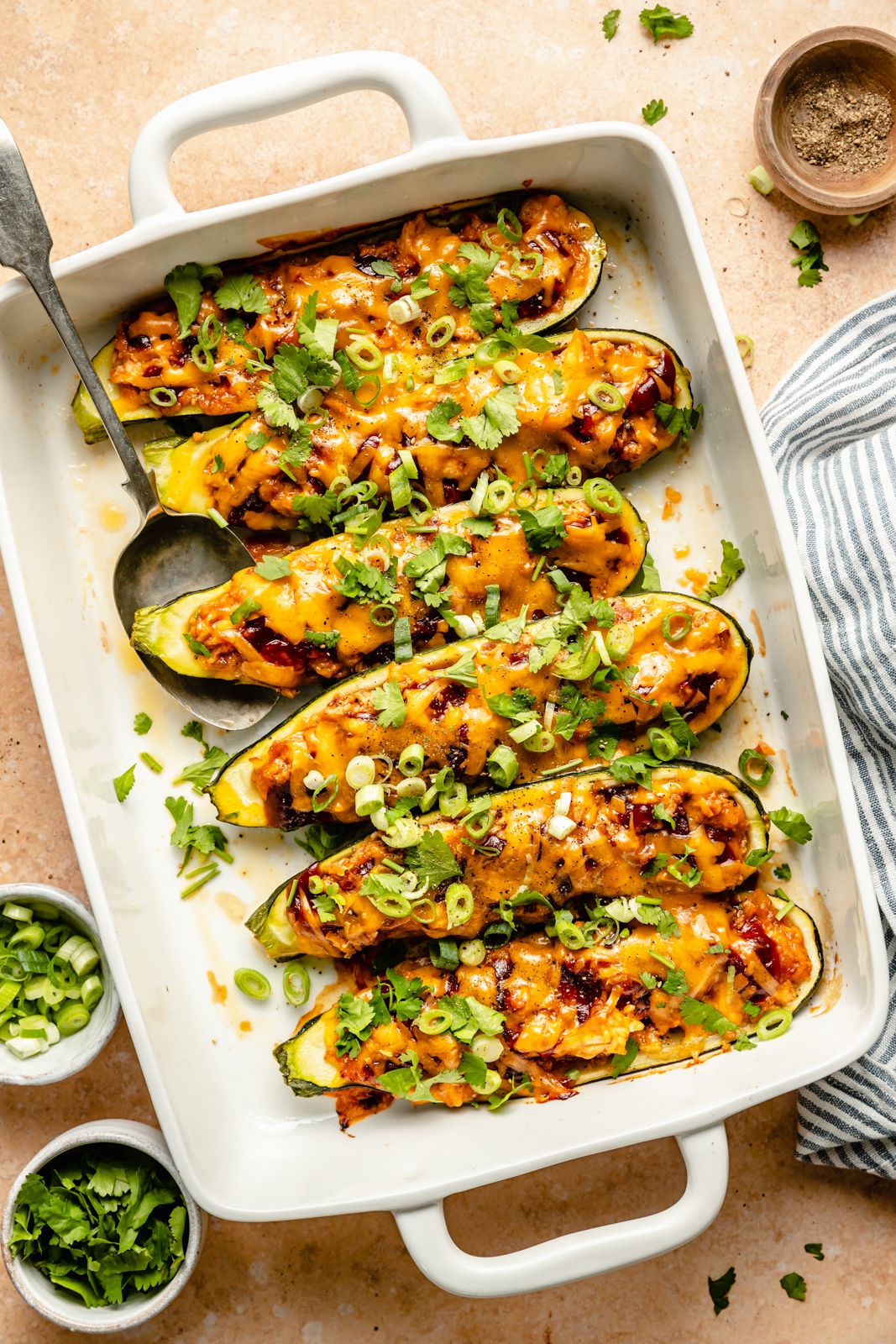 bbq chicken stuffed zucchini boats in a baking pan