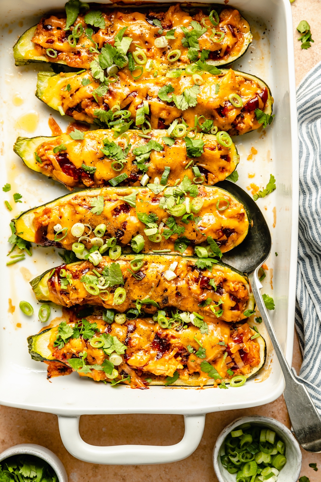 bbq chicken stuffed zucchini boats in a baking pan