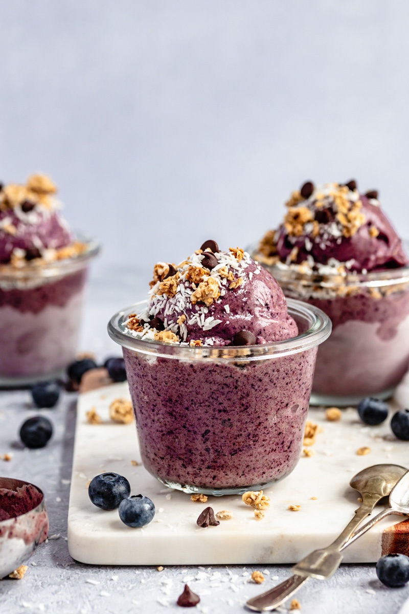 vegan blueberry nice cream in a bowl topped with granola and coconut