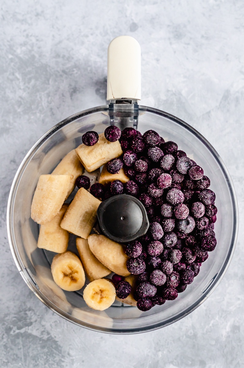 frozen blueberries and frozen bananas in a food processor