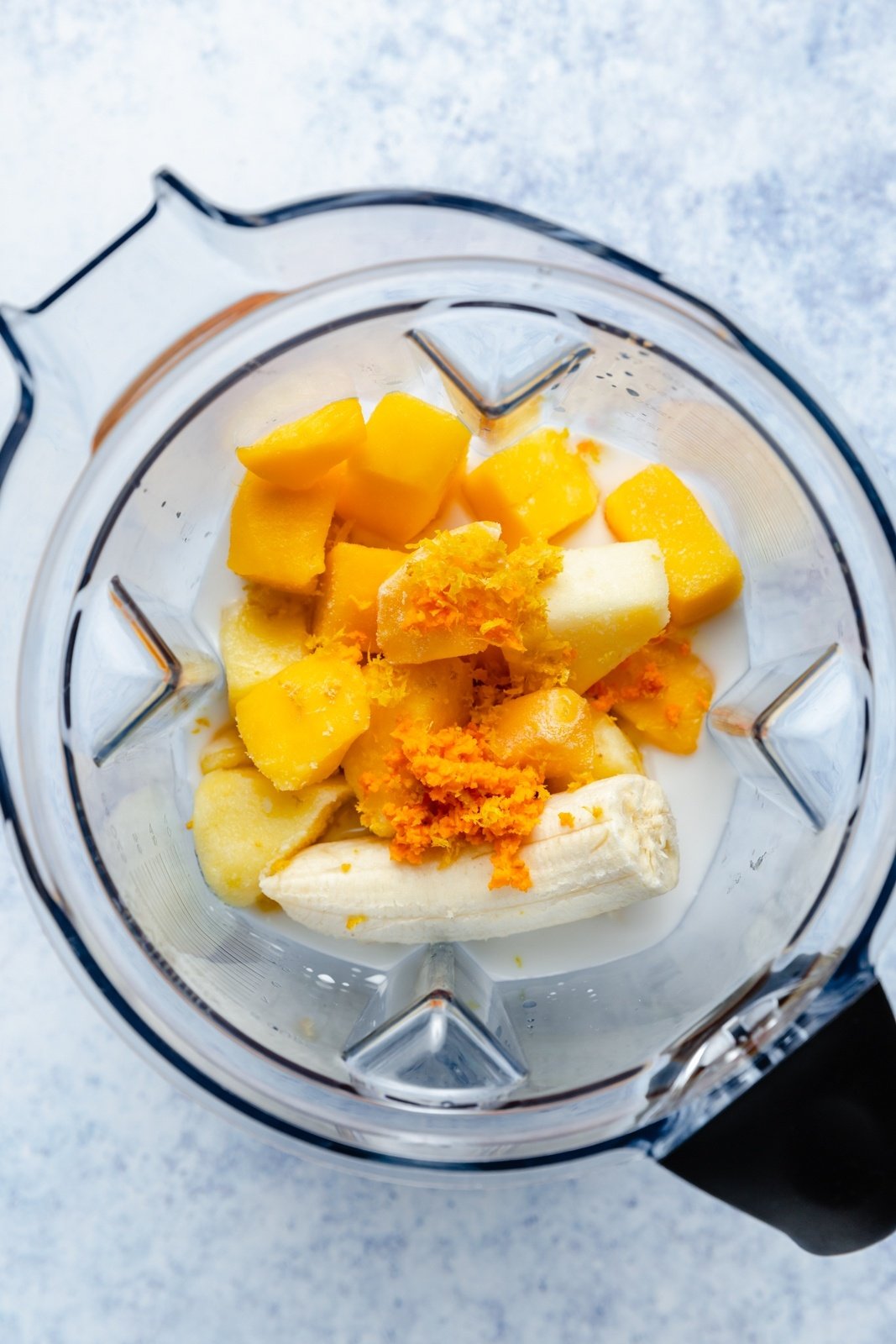 ingredients for a turmeric smoothie in a blender