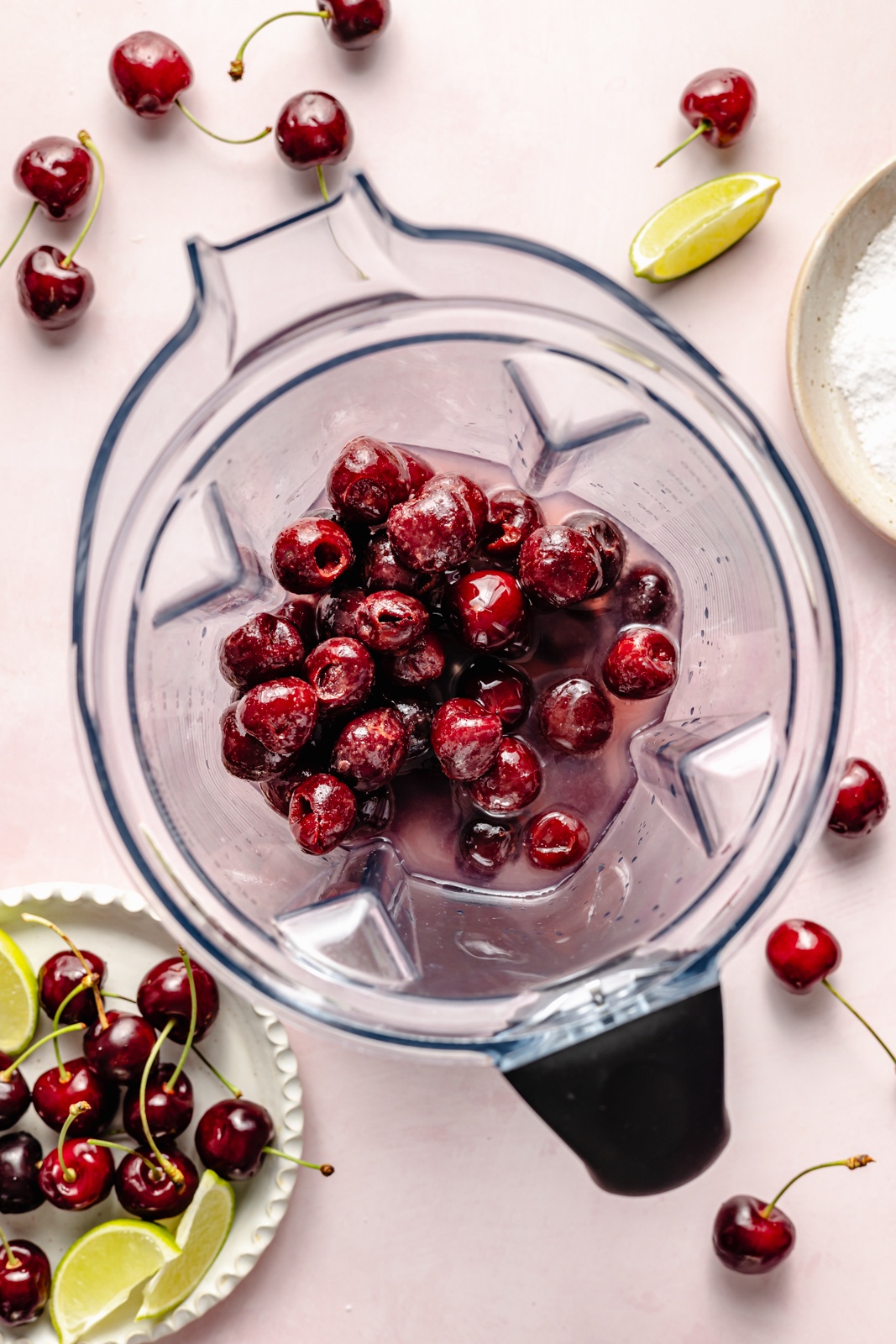 frozen cherries in a blender to make a frozen cherry lime margarita