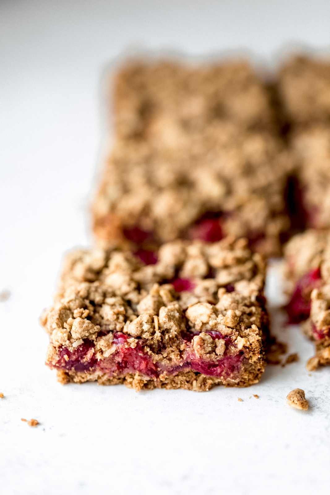 tart cherry pie bars cut into square on a white board