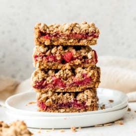 four tart cherry pie bars in a stack on a plate