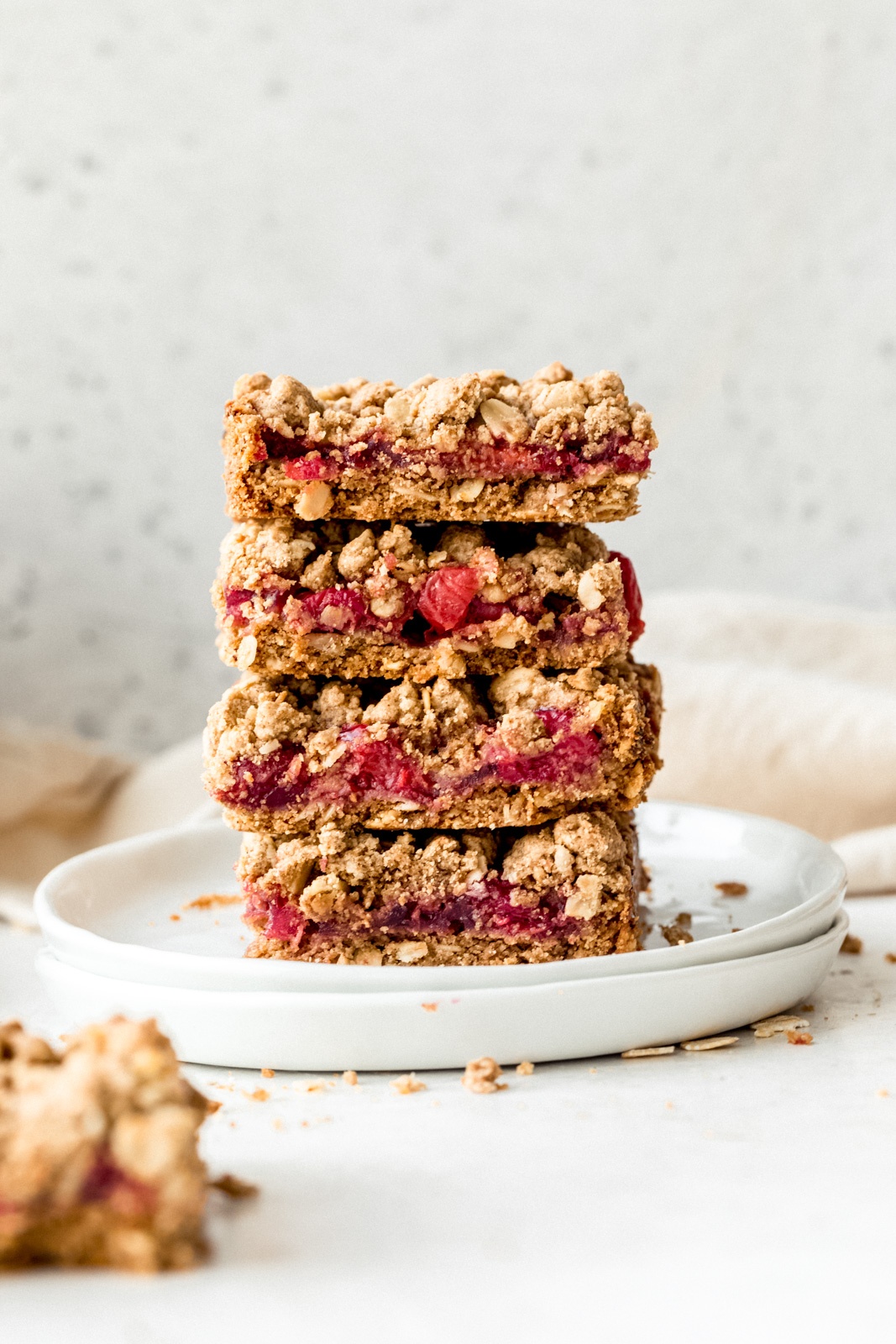 four tart cherry pie bars in a stack on white plates