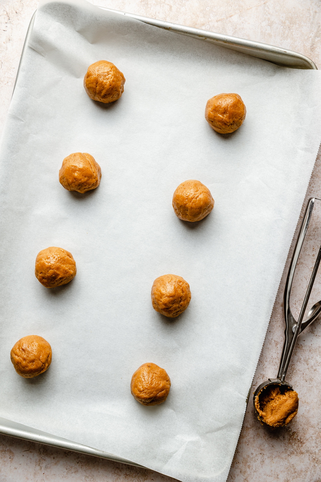 unbaked peanut butter cookies on a baking sheet