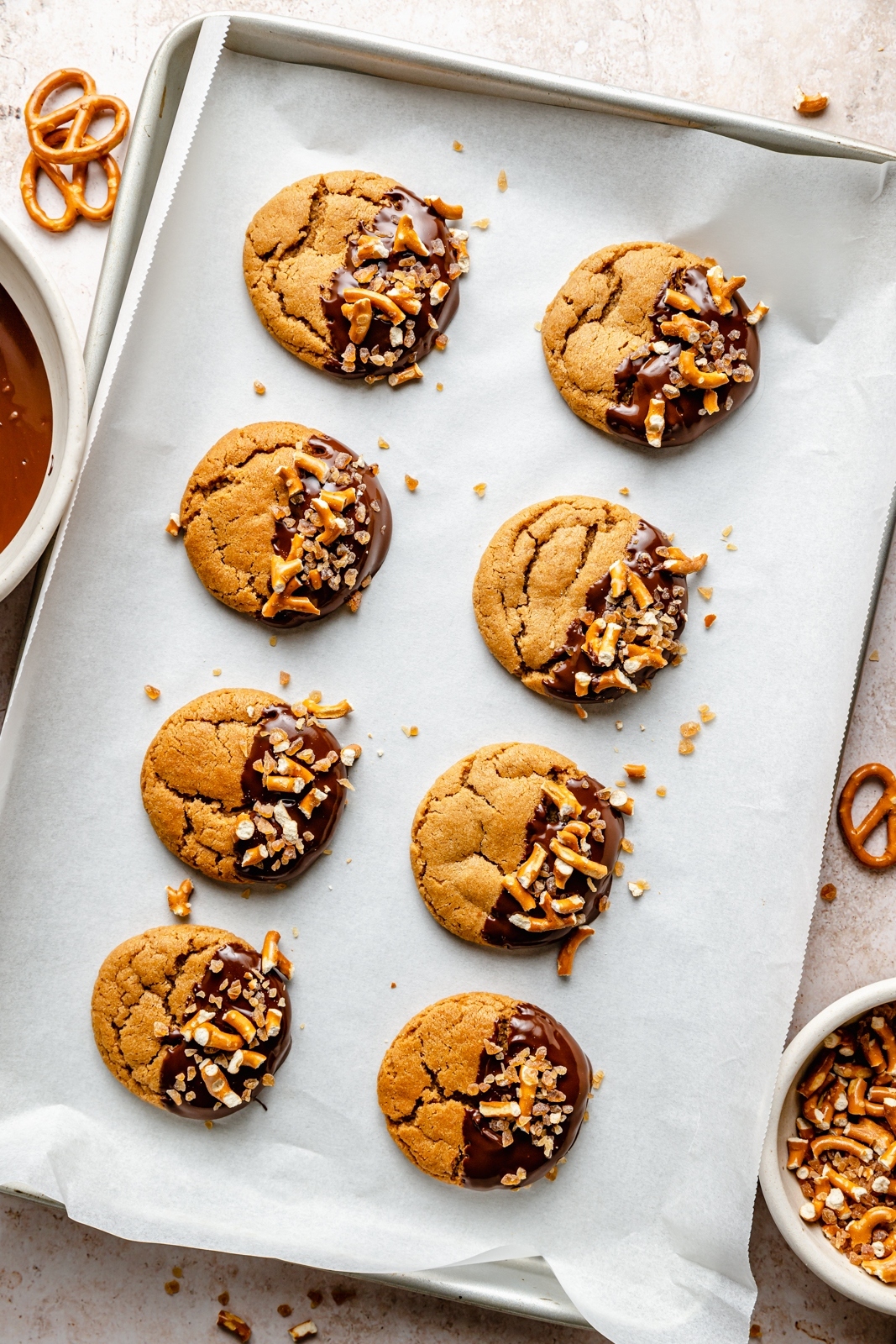 chocolate dipped peanut butter cookies on a baking sheet