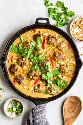 cilantro chicken meatballs in a skillet with mango coconut sauce