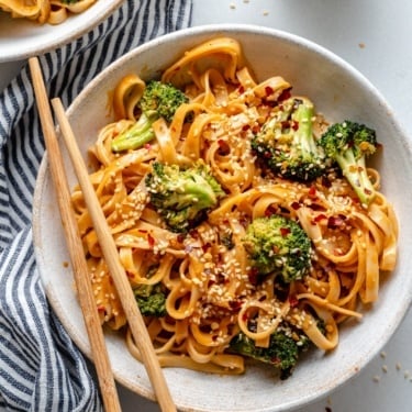 vegan tahini noodles with broccoli in a bowl