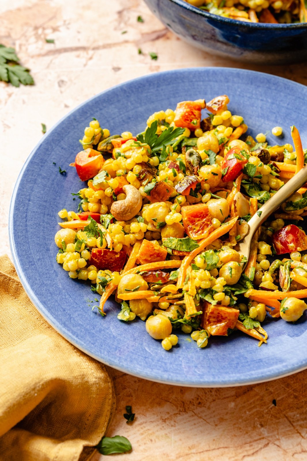 curried chickpea couscous salad on a blue plate