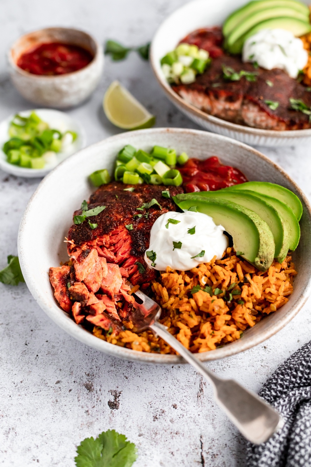 healthy salmon taco bowl topped with avocado and greek yogurt