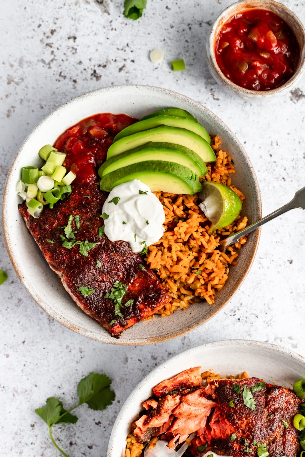 healthy salmon taco bowl topped with avocado and greek yogurt