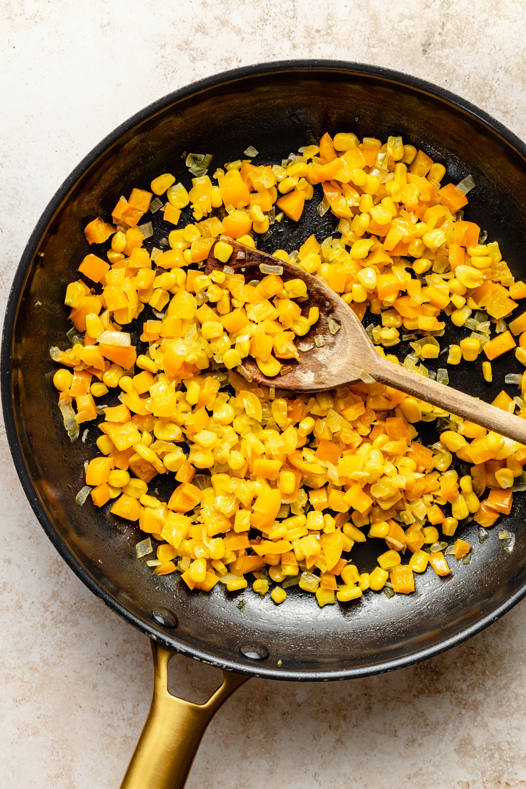 sautéing vegetables in a skillet to make a vegetarian southwest bean dip