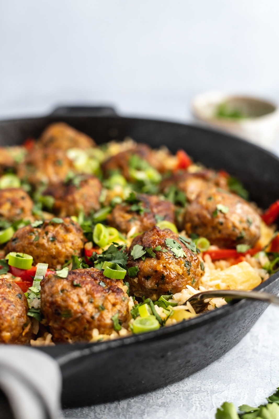 one pan firecracker chicken meatballs with rice in a pan