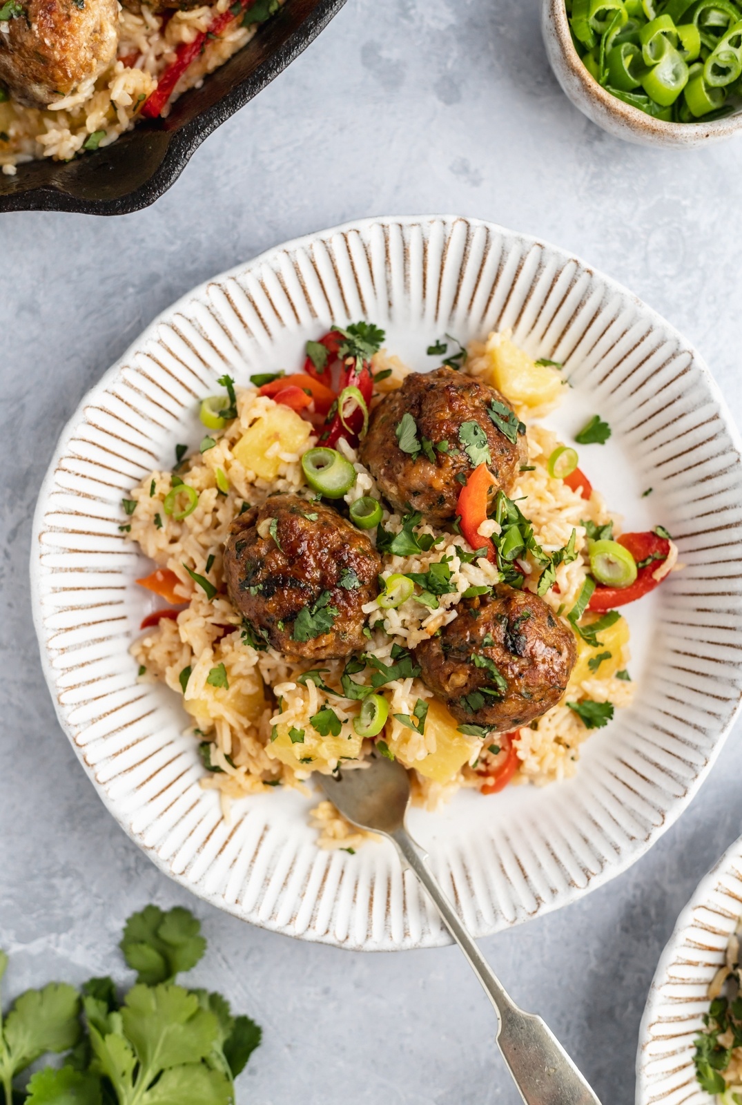 firecracker chicken meatballs on a plate with cilantro rice