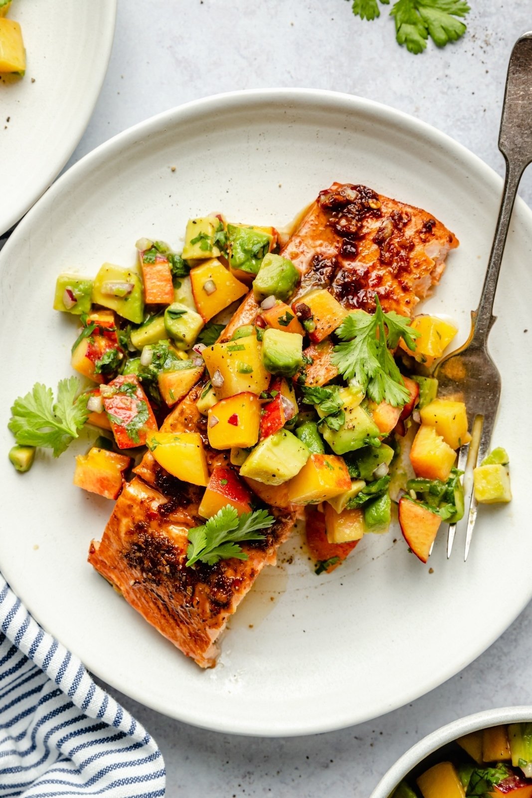 firecracker salmon on a plate with peach salsa