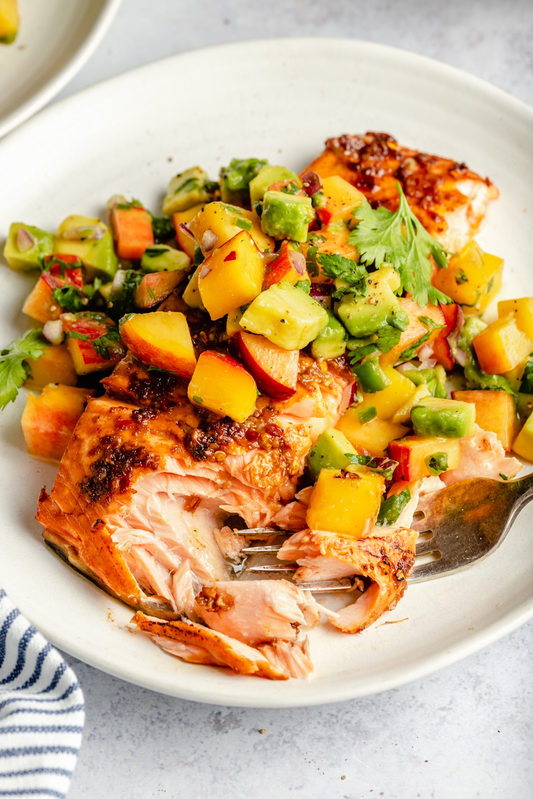 firecracker salmon on a plate with peach salsa