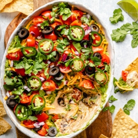 healthy 7-layer dip in a serving bowl