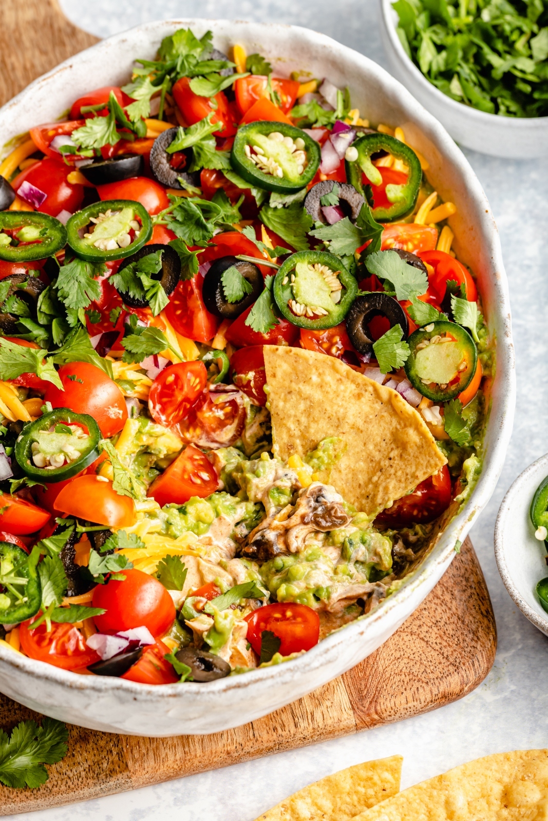 healthy 7-layer dip in a serving bowl