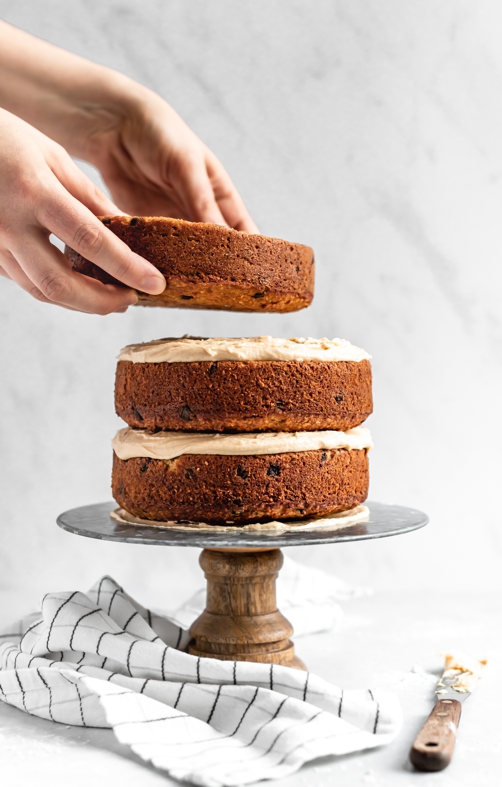 stacking layers of a gluten free peanut butter banana cake