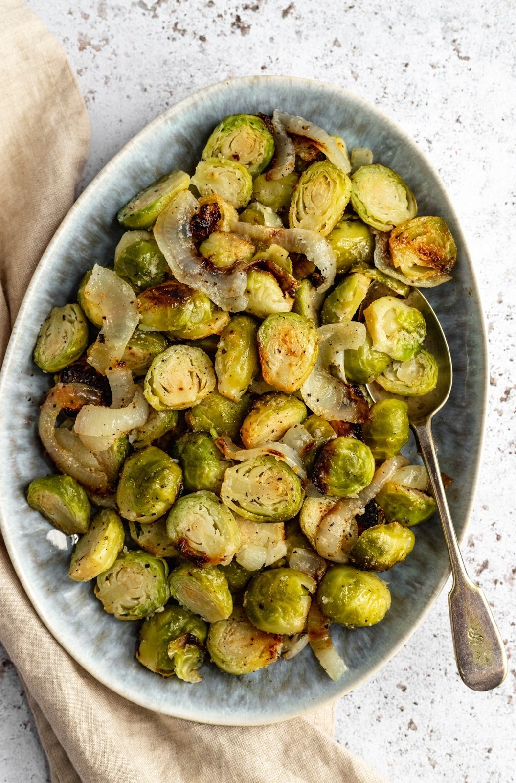 foil pack grilled brussels sprouts in a dish with a spoon