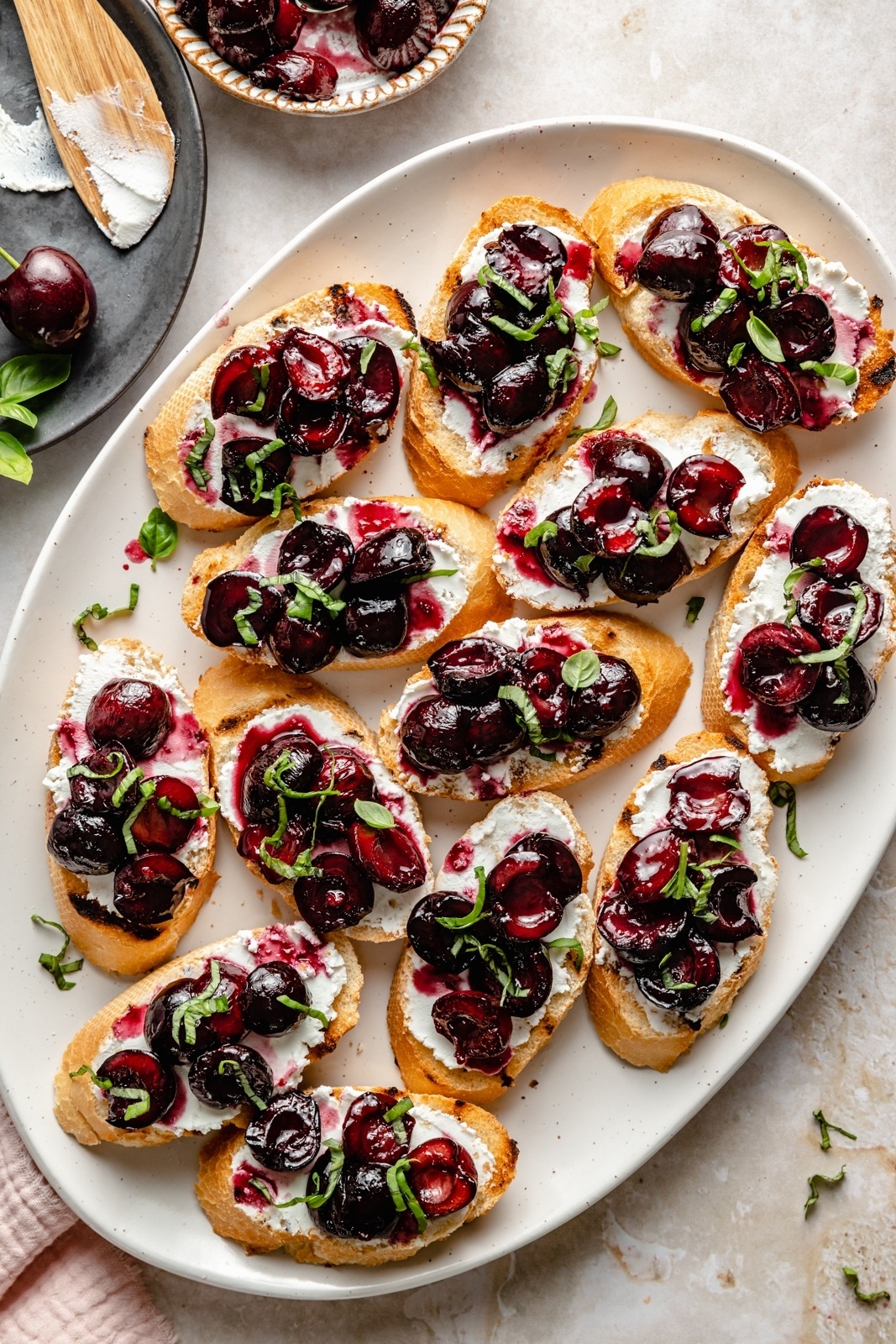 grilled crostini with roasted cherries and ricotta on a platter