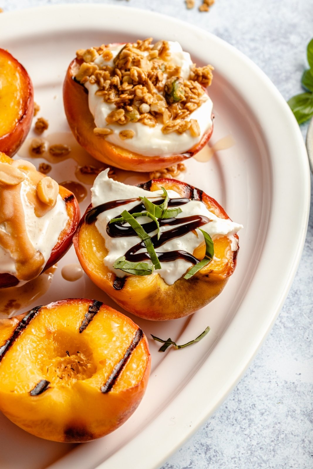 sweet and savory grilled peaches on a platter