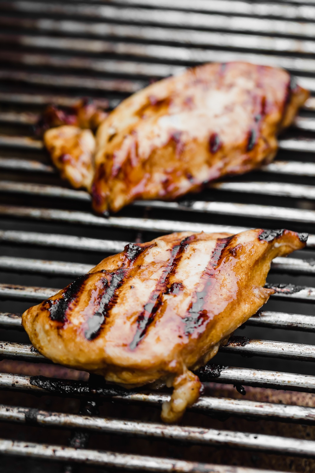 two chicken breasts on a grill