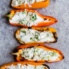 grilled stuffed mini peppers in a line