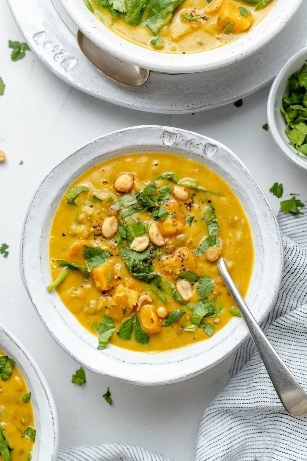 butternut squash lentil soup in a bowl topped with cilantro