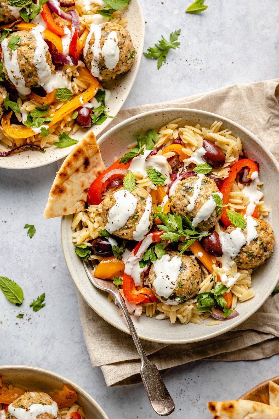 easy Greek turkey meatballs with orzo and feta sauce in bowls