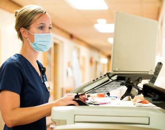 Medical professional in front of a hospital computer