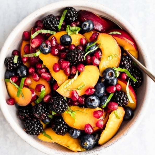 summer peach berry fruit salad in a bowl