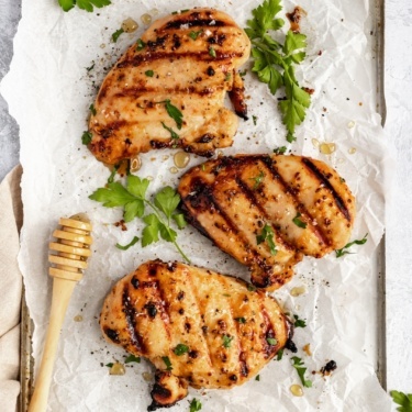 honey mustard marinated chicken on parchment paper