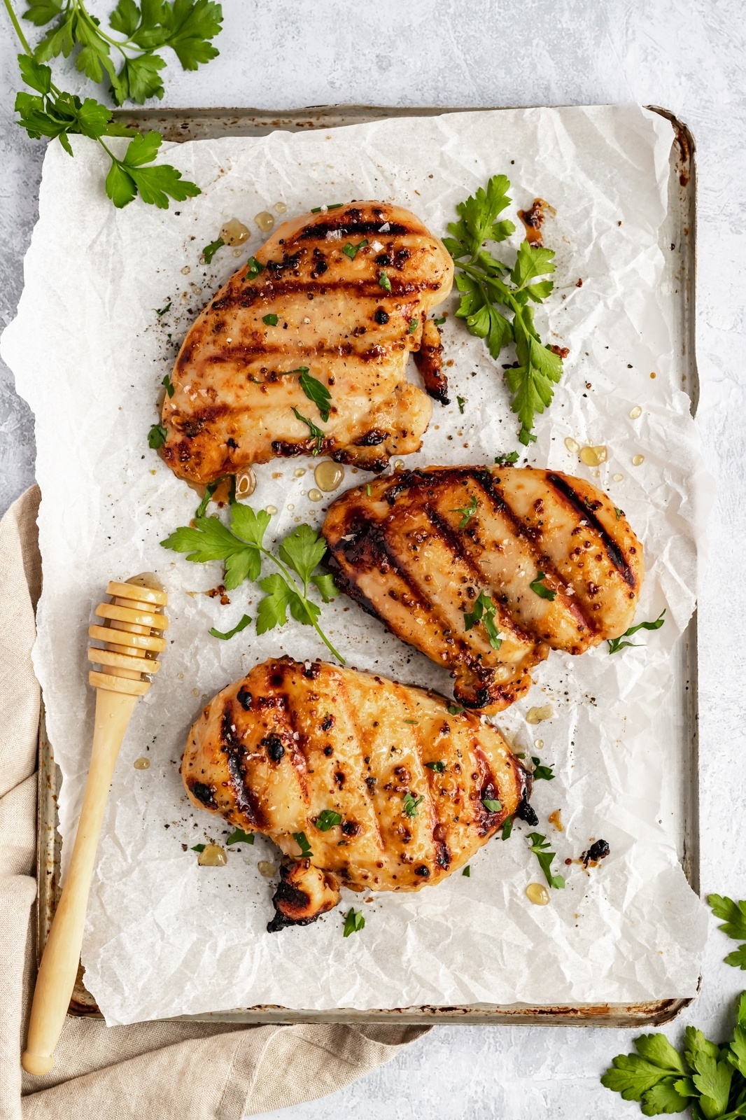 honey mustard marinated chicken on parchment paper