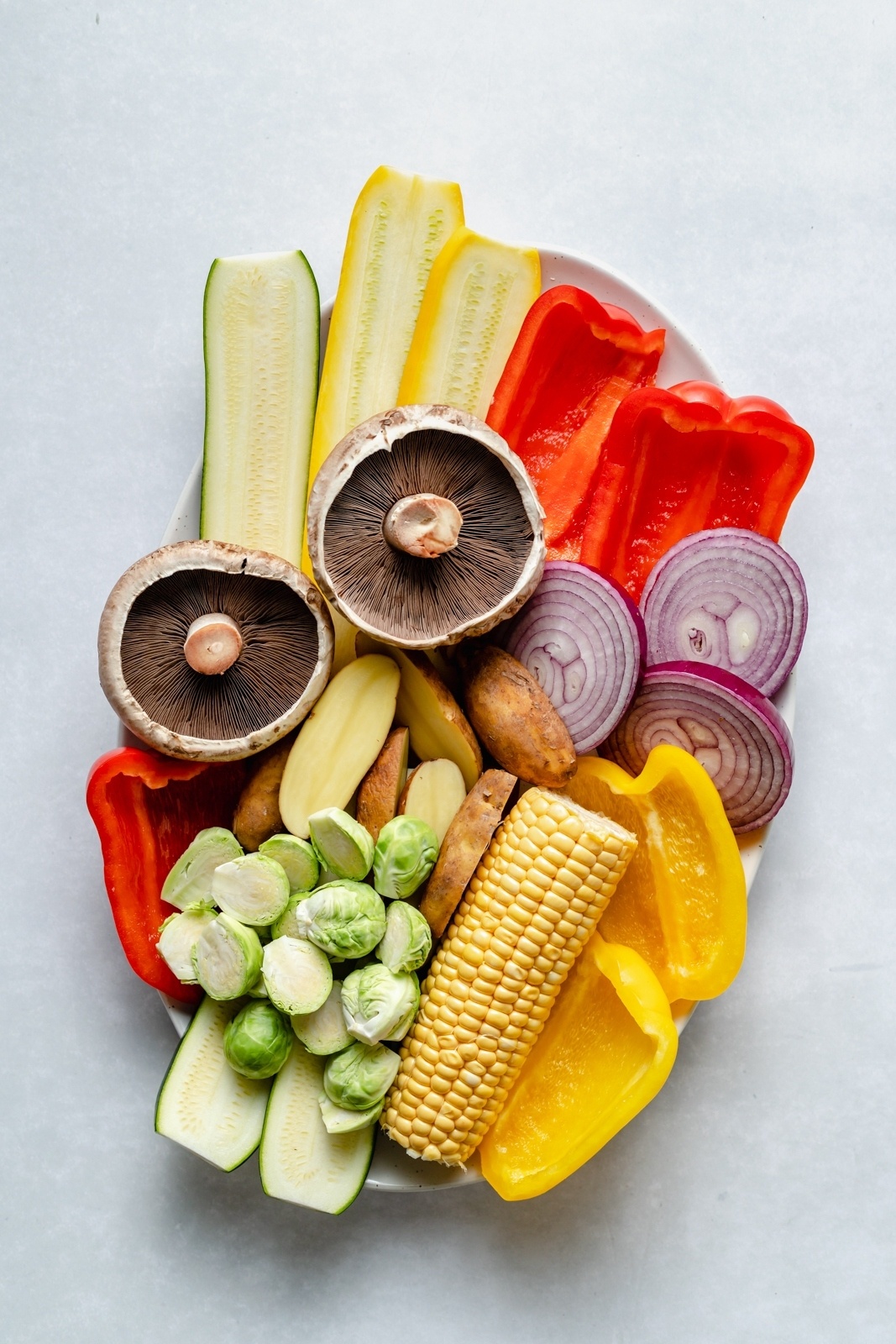 sliced vegetables on a platter for grilling