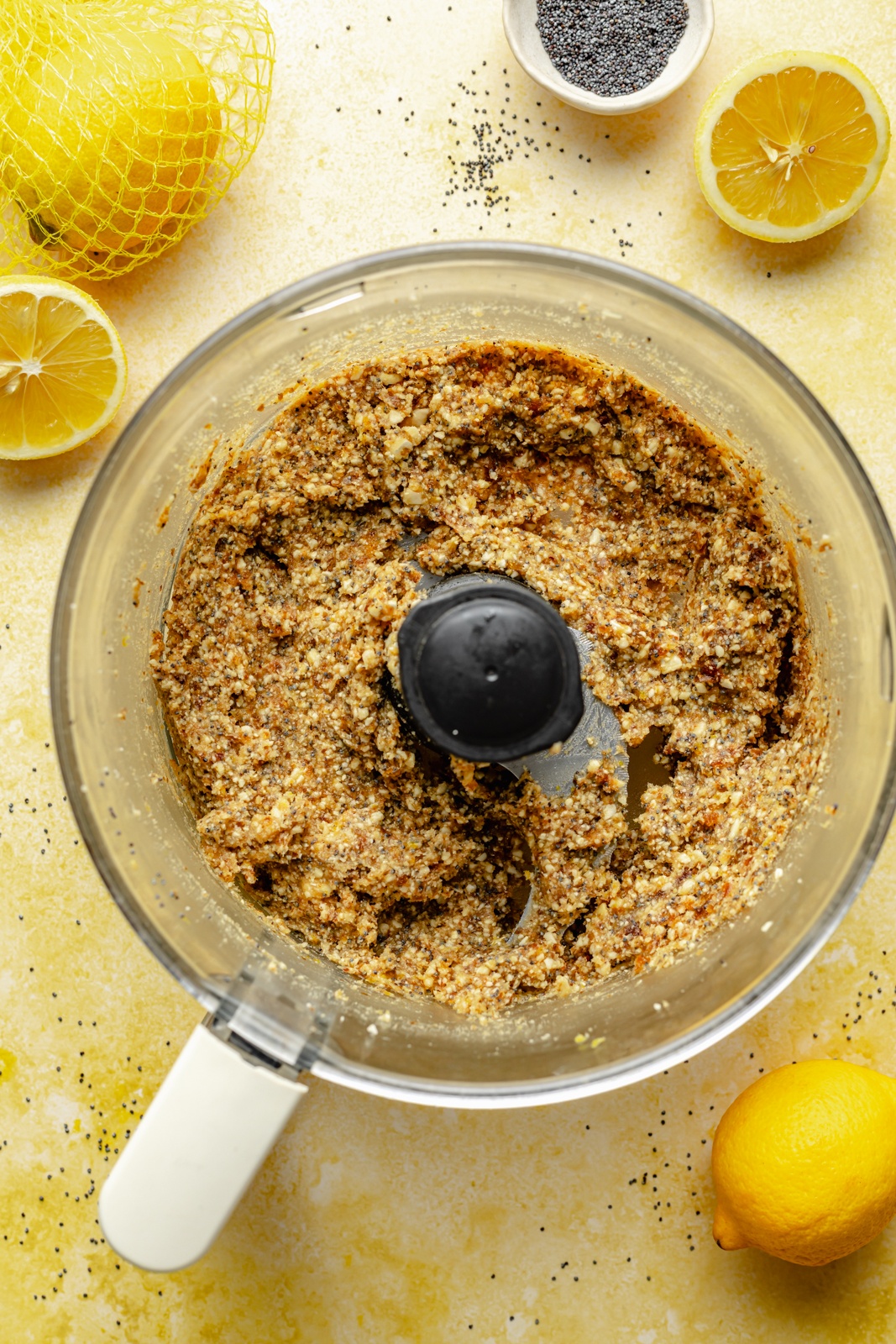 ingredients for lemon poppy seed energy bites blended in a food processor