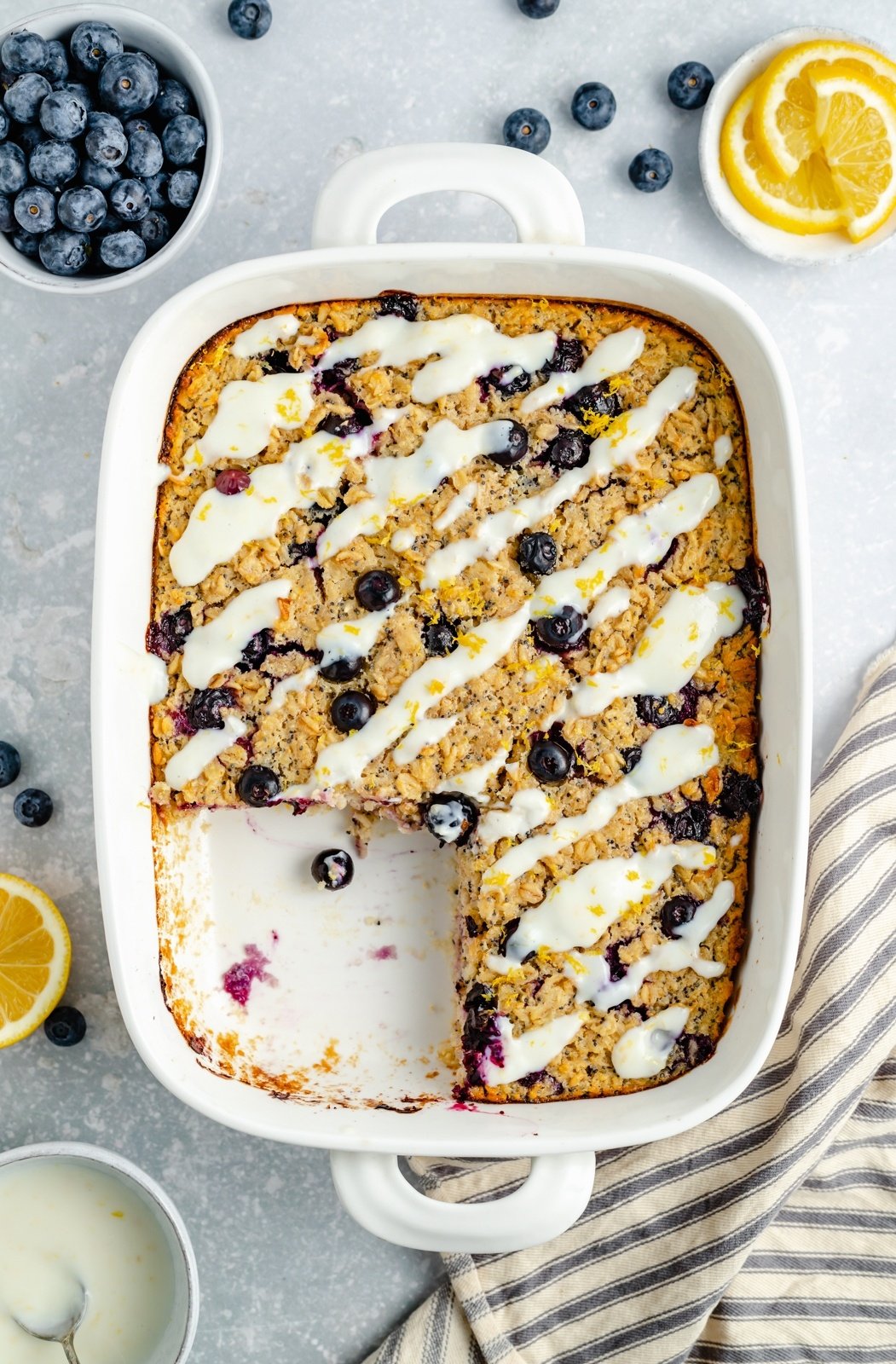 lemon blueberry oatmeal bake in a baking dish with a slice cut out