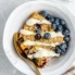 lemon blueberry oatmeal bake in a bowl with blueberries