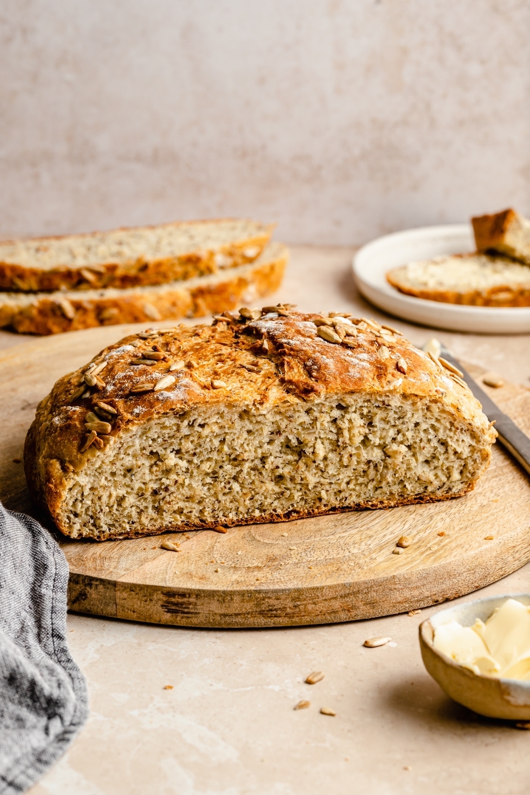 honey oatmeal artisan bread sliced on a wooden board