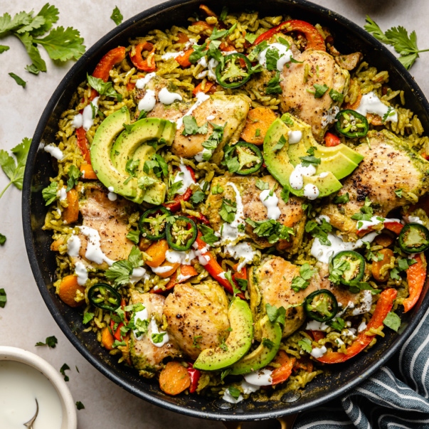 green chicken and rice in a skillet