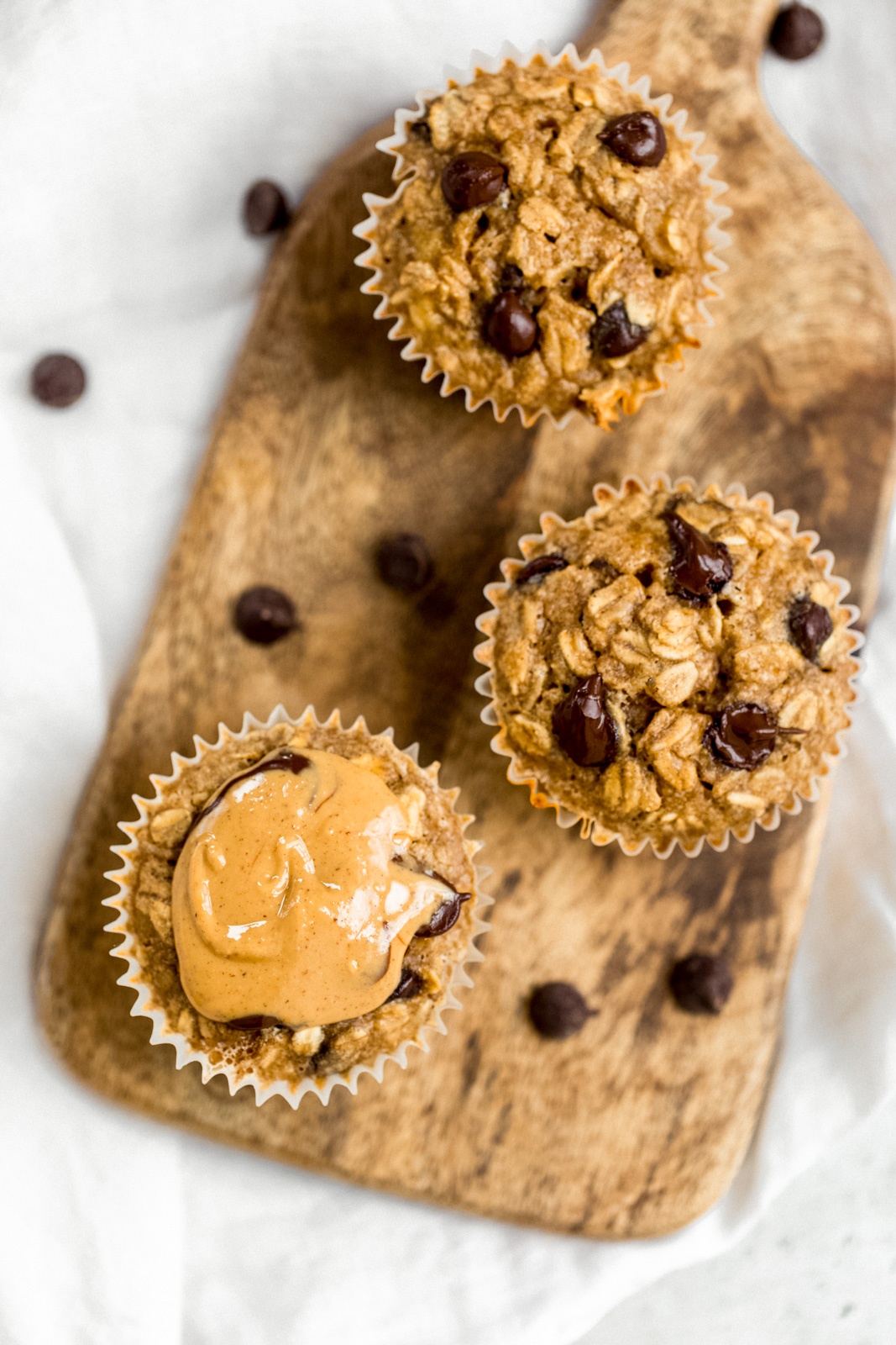 peanut butter banana baked oatmeal cups on a wooden serving board