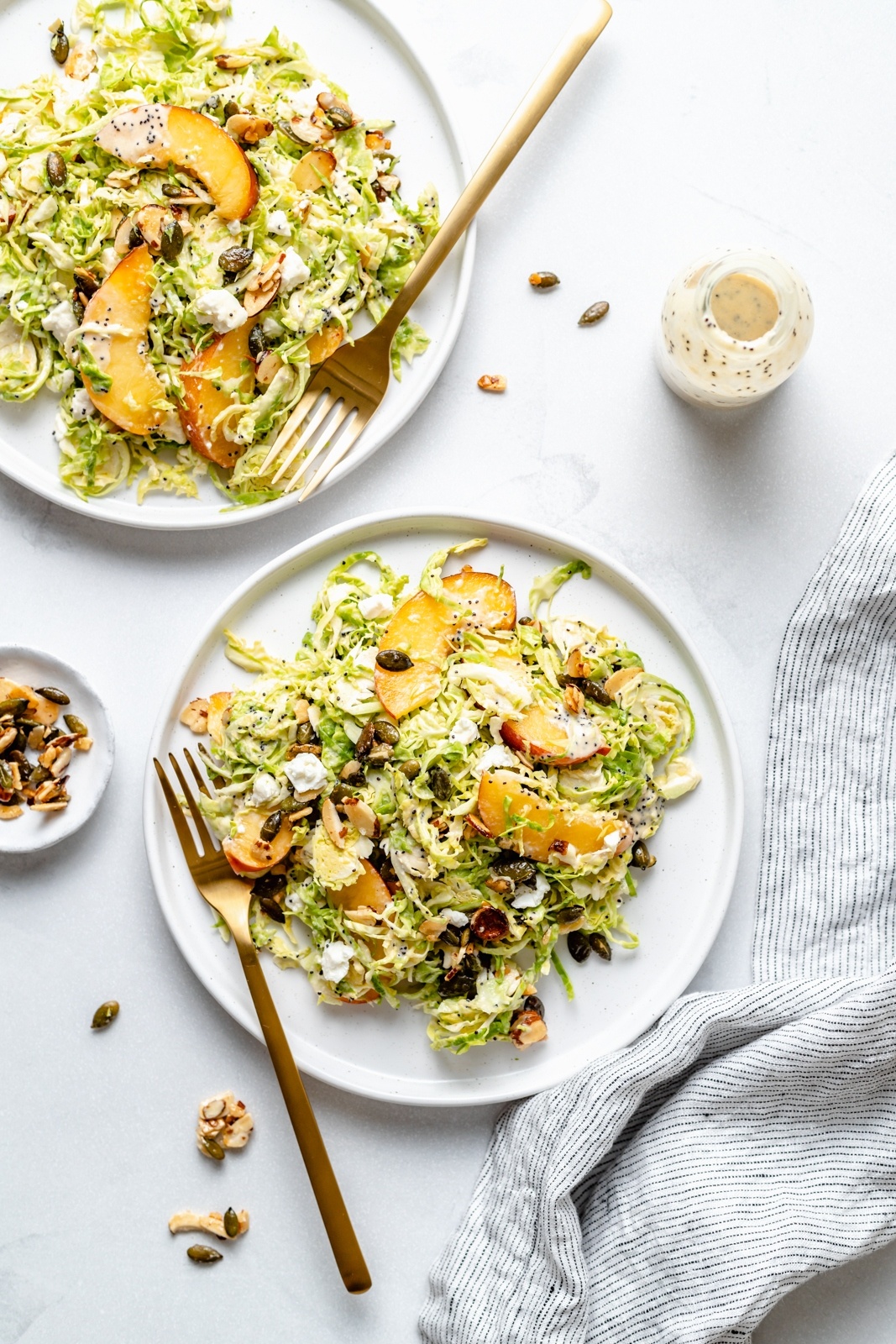 healthy peach brussels sprouts salad on two plates