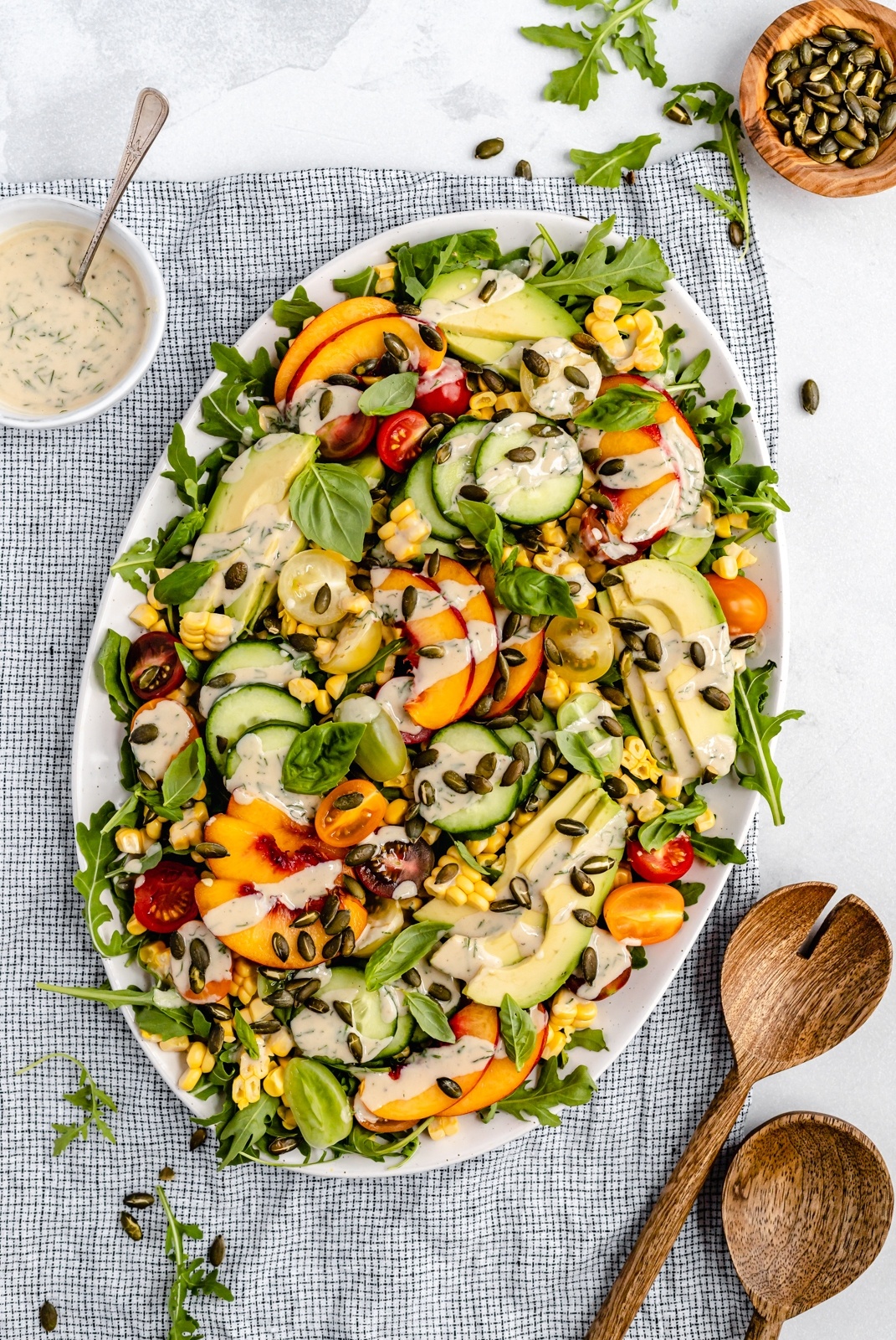 avocado peach tomato salad on a serving platter