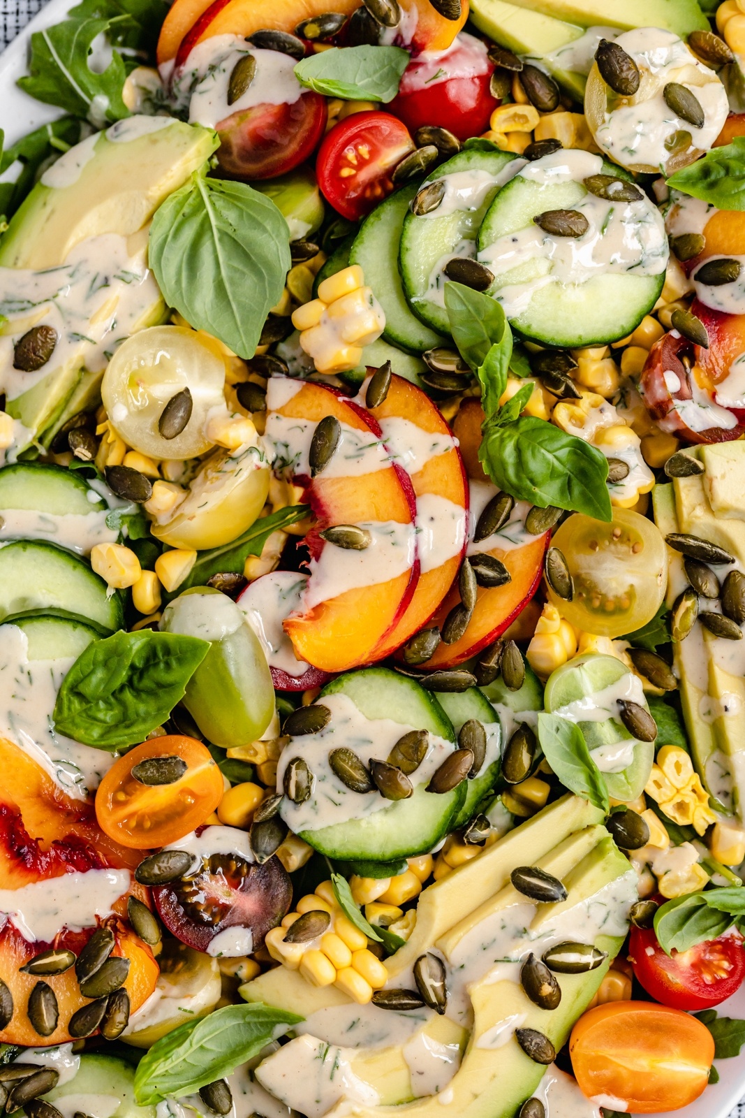 up close photo of an avocado peach tomato salad