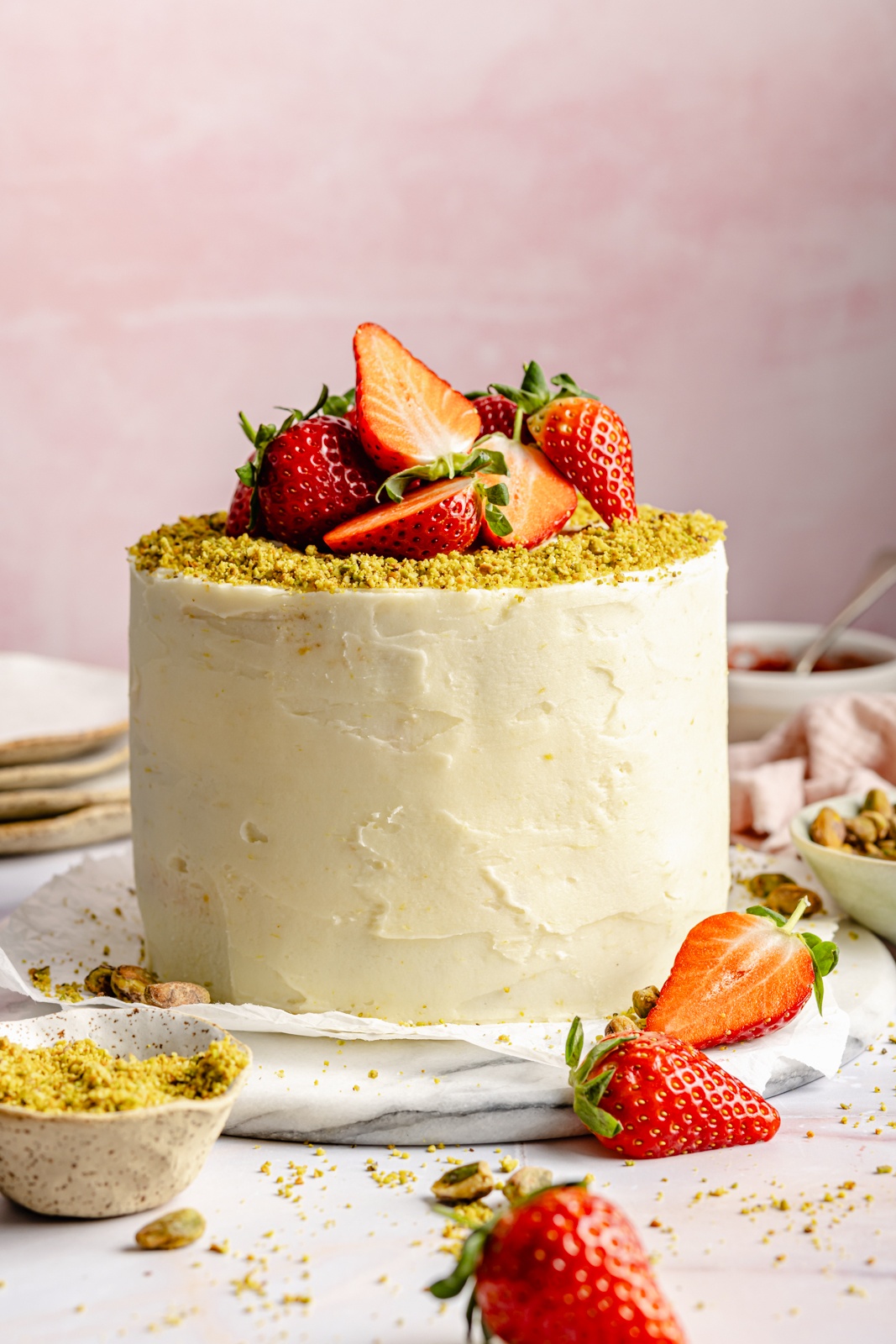 lemon pistachio cake topped with strawberries