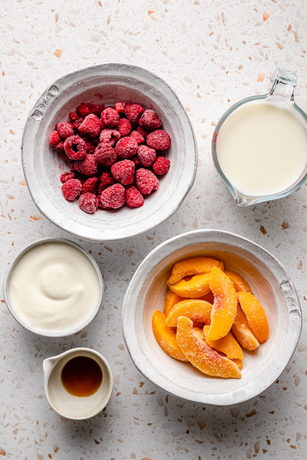 ingredients for a peach smoothie without banana in bowls